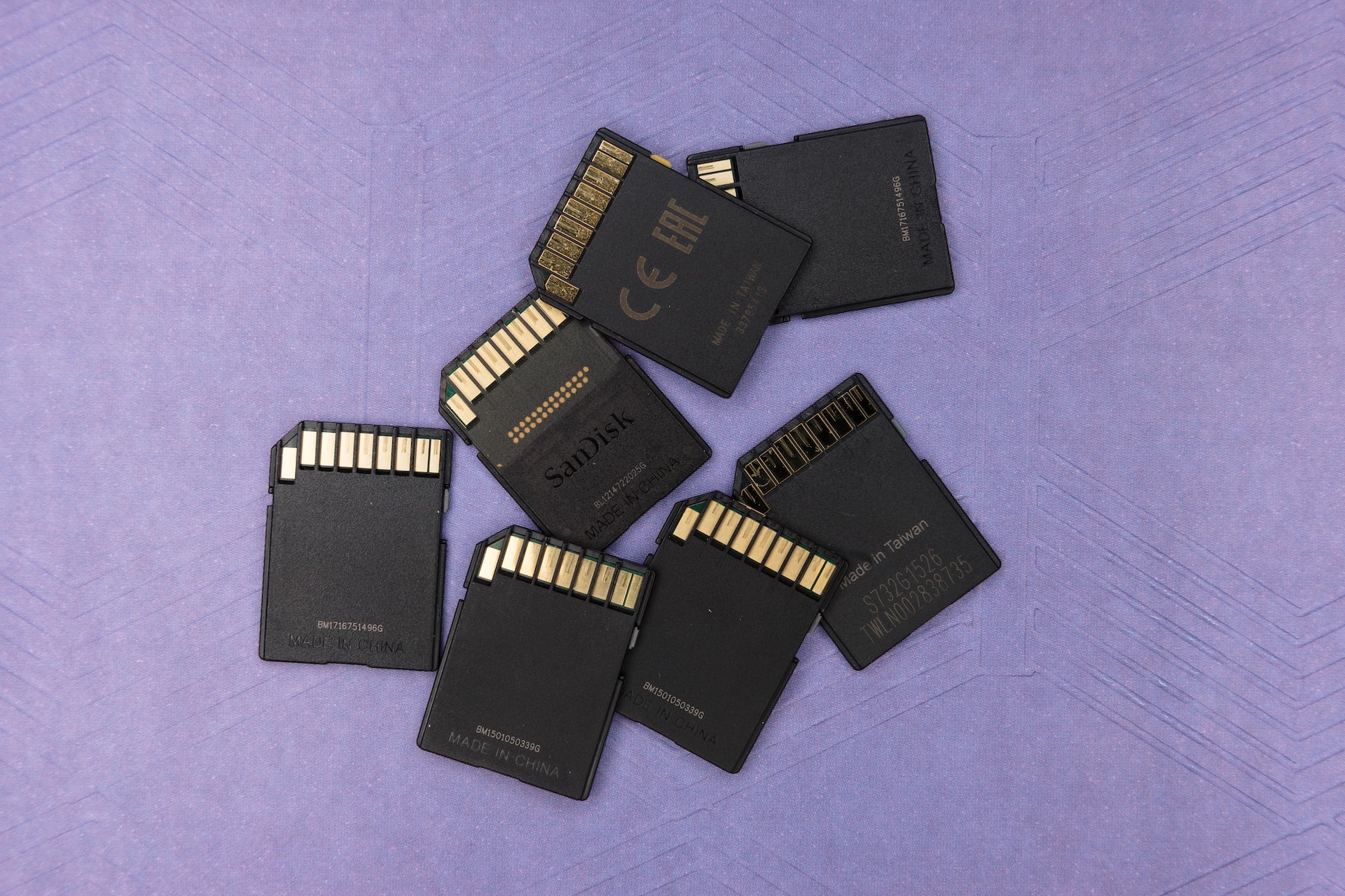 A stack of SD data storage cards on a purple background, representing evidence preservation and injunctions