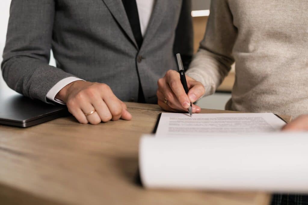 photo of people signing a marriage contract to resolve property dispute issues