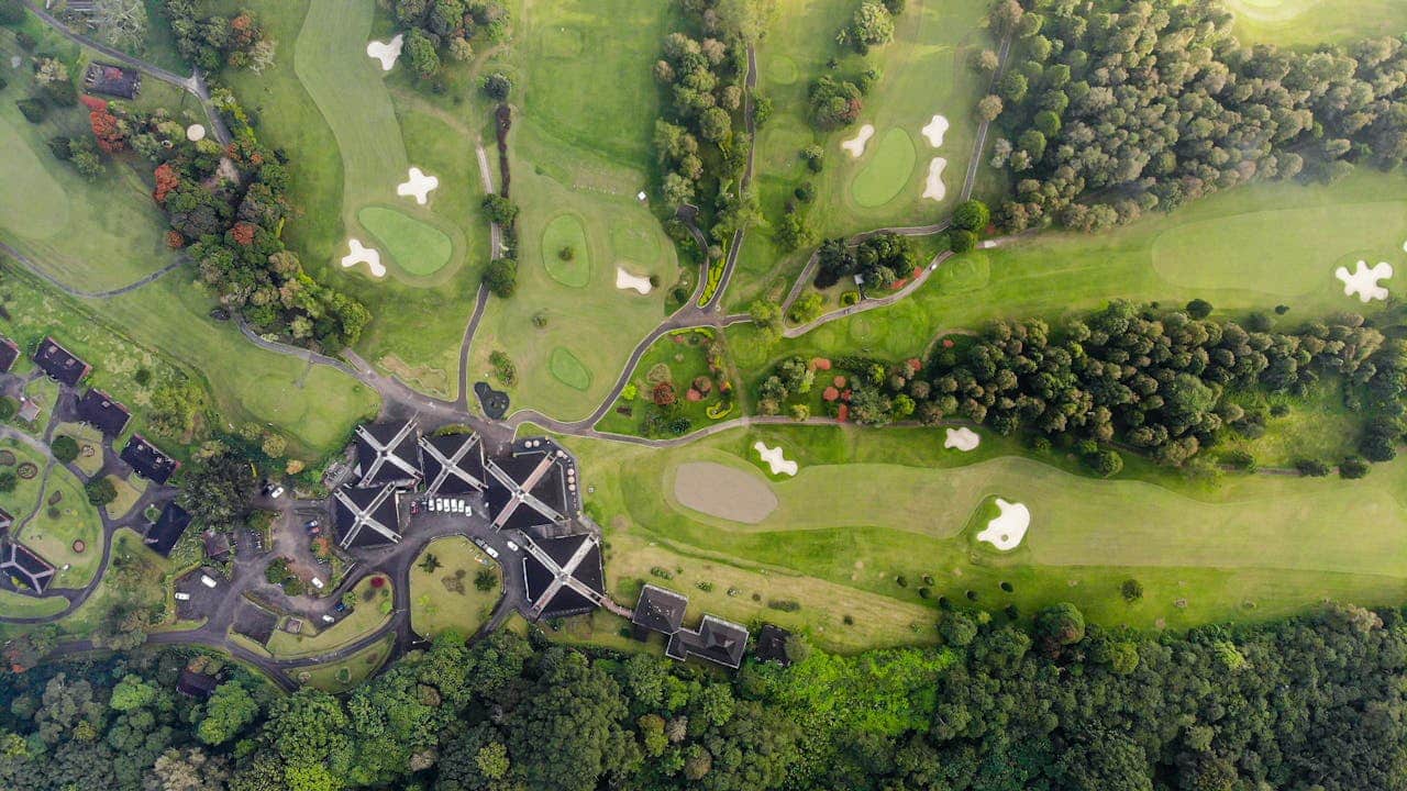 Bird's eye view of golf course representing disputes arising in real estate development projects.