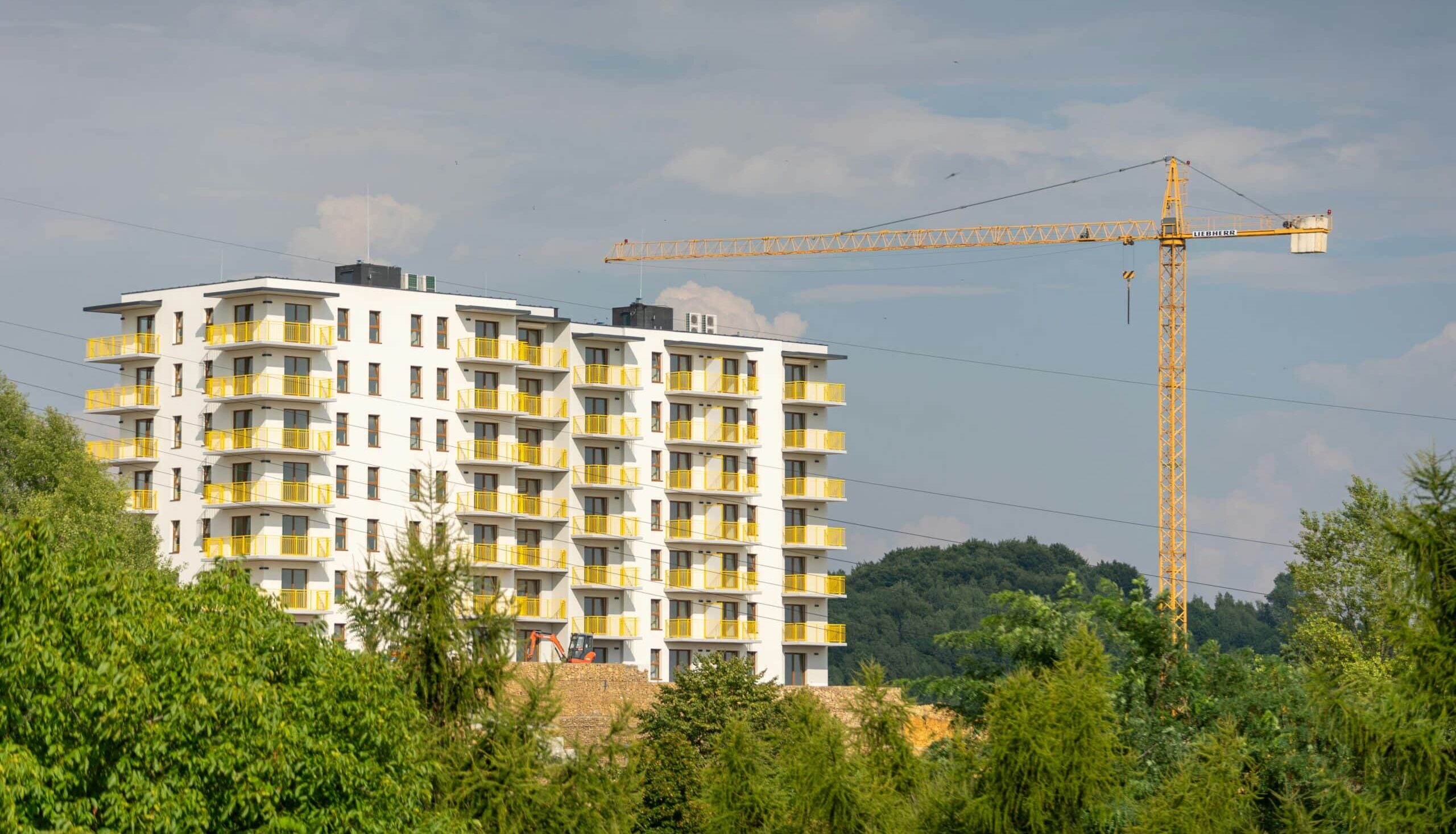 A high-rise condo building under construction, representing pre-sale misrepresentations by real estate developers
