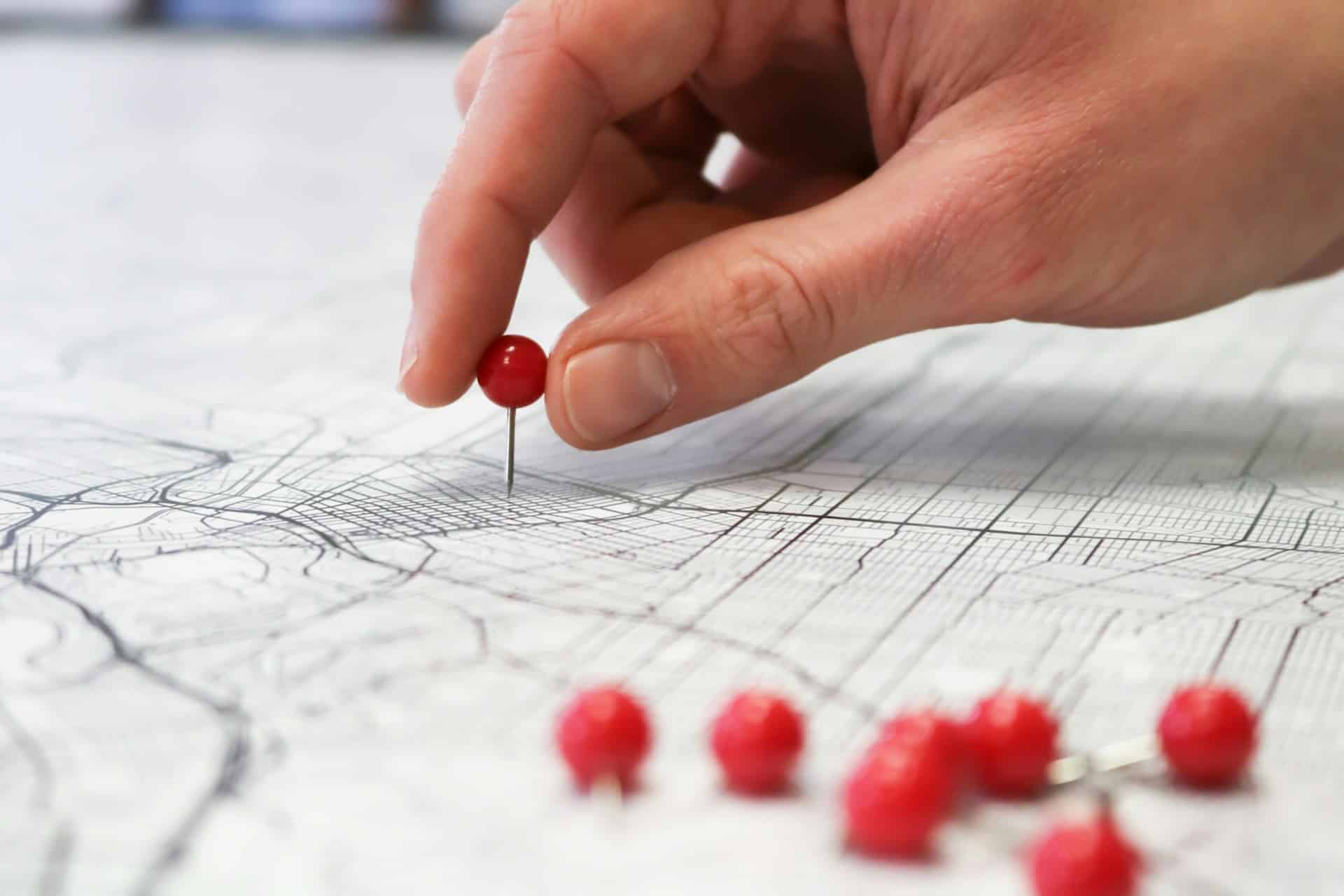 person holding red round button