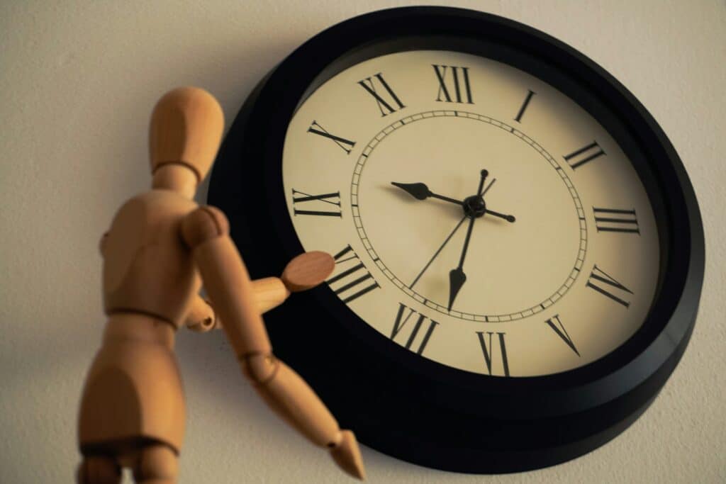 a wooden toy by a clock