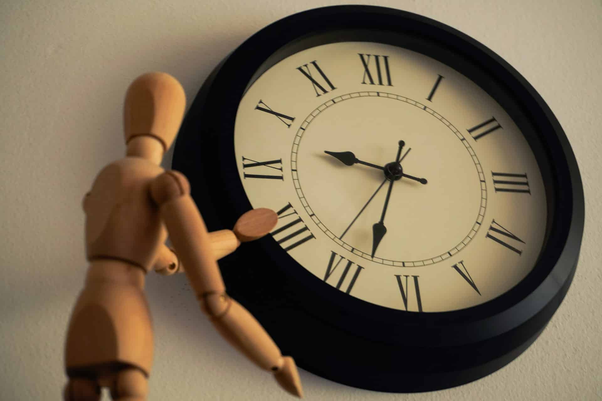 a wooden toy by a clock