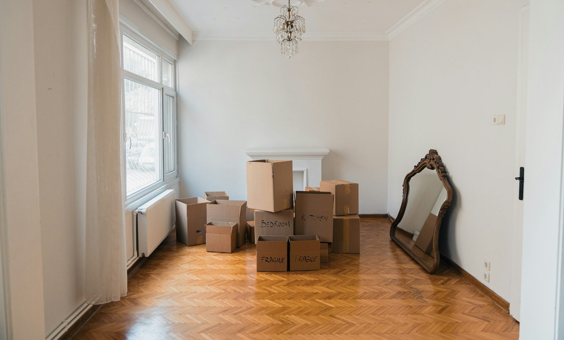 An empty room with moving boxes packed, representing mobility and relocation with children during complex divorce proceedings in Vancouver family law.
