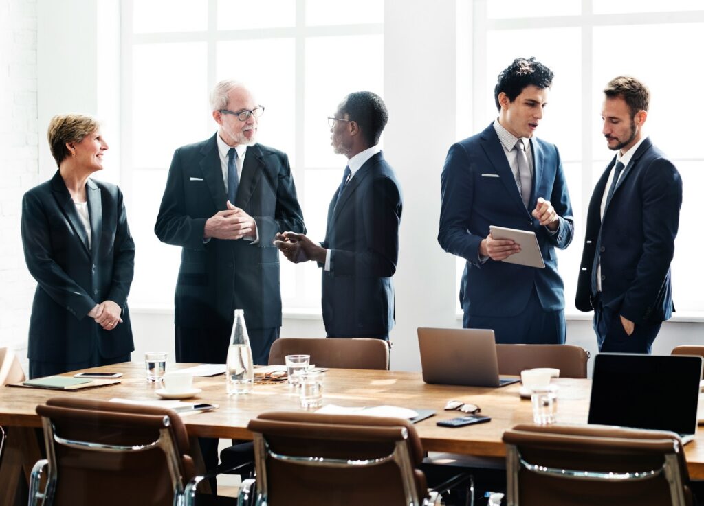 A group of business people having settlement negotiations in a boardroom, representing mitigation of litigation risk in settlement agreements in Vancouver